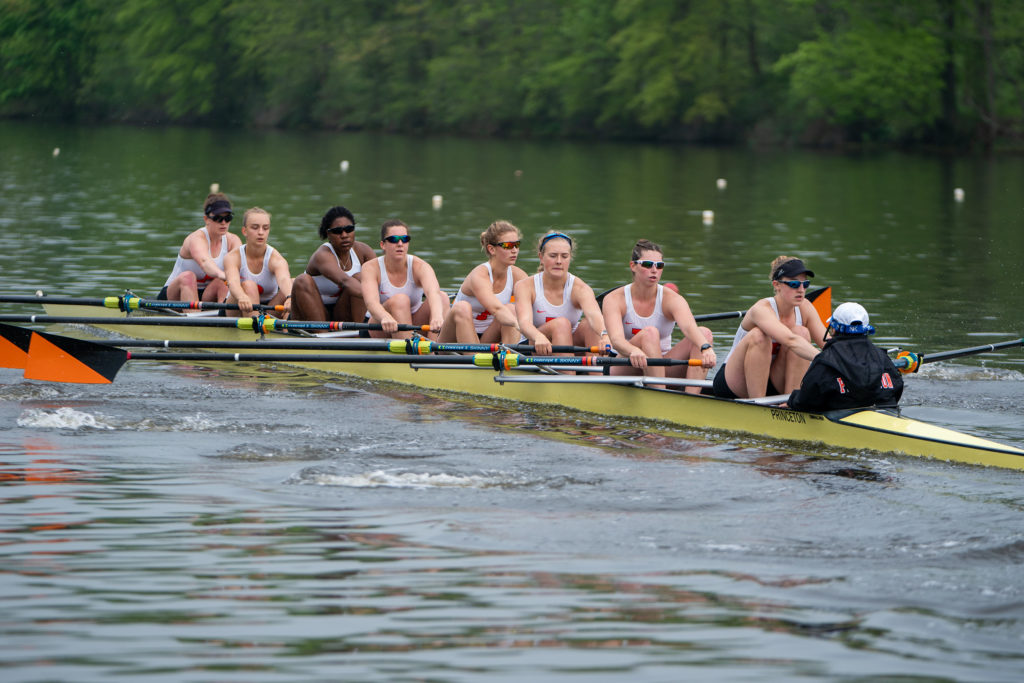 A group of people rowing a boat in the water