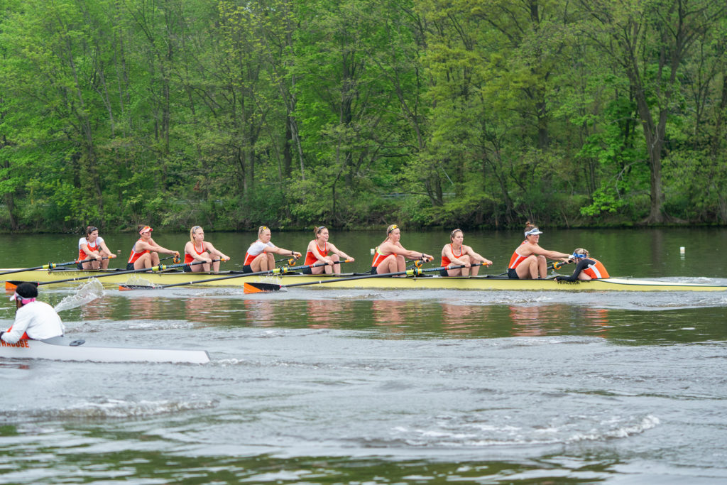 A group of people rowing a boat in the water