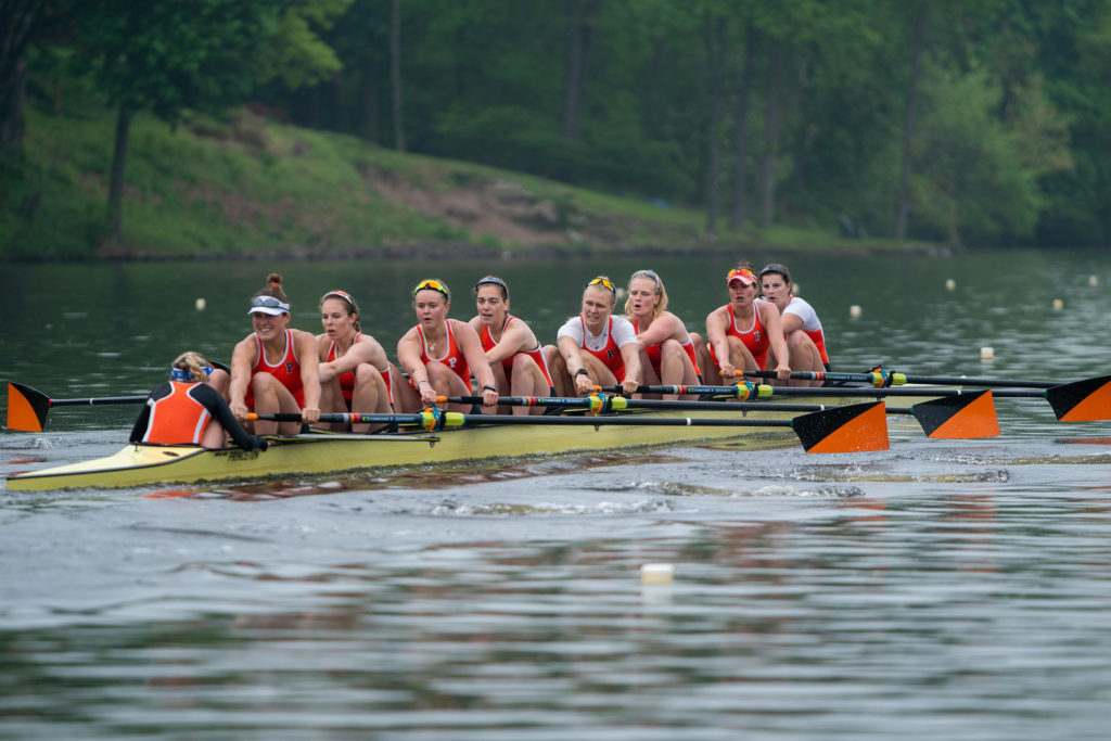 A group of people rowing a boat in the water