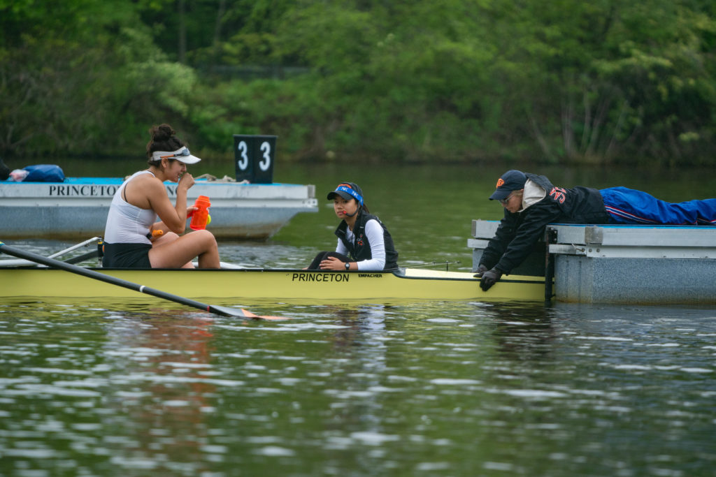 A group of people rowing a boat in the water