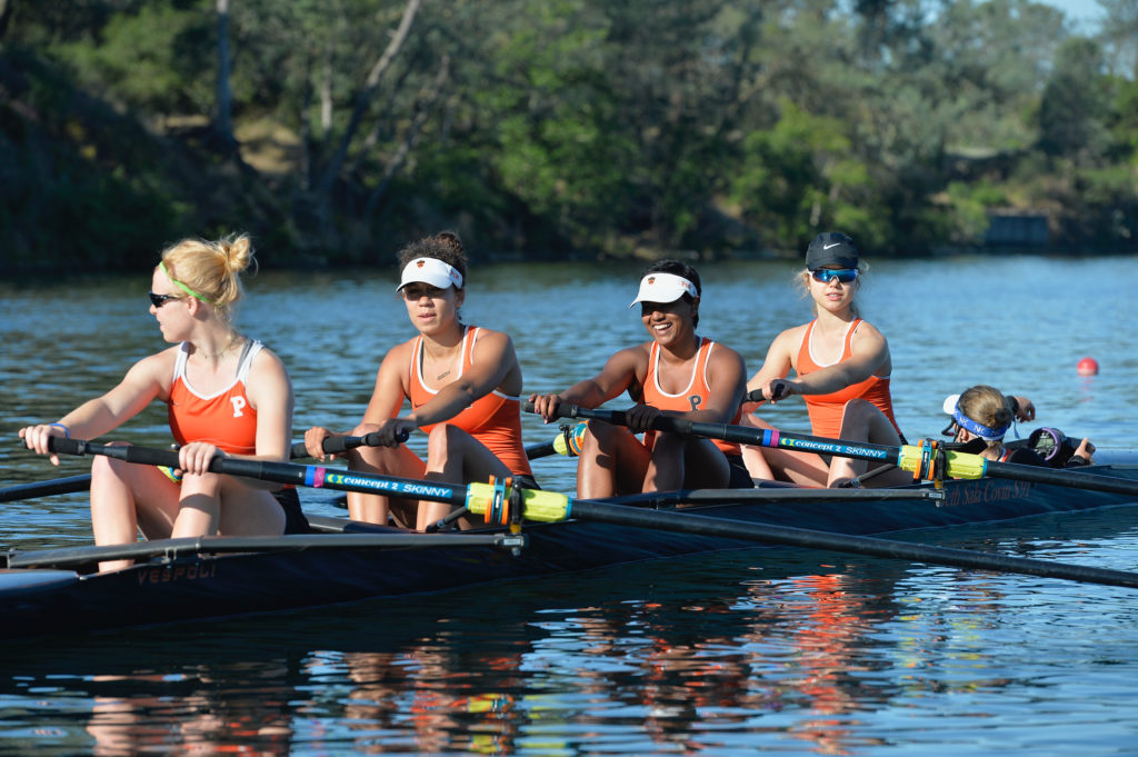 A group of people rowing a boat in the water