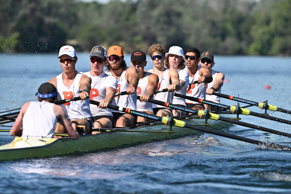 A group of people rowing a boat in the water