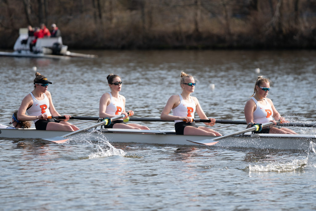 A group of people rowing a boat in the water