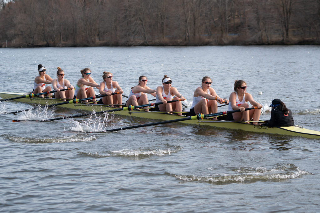 A group of people rowing a boat in the water