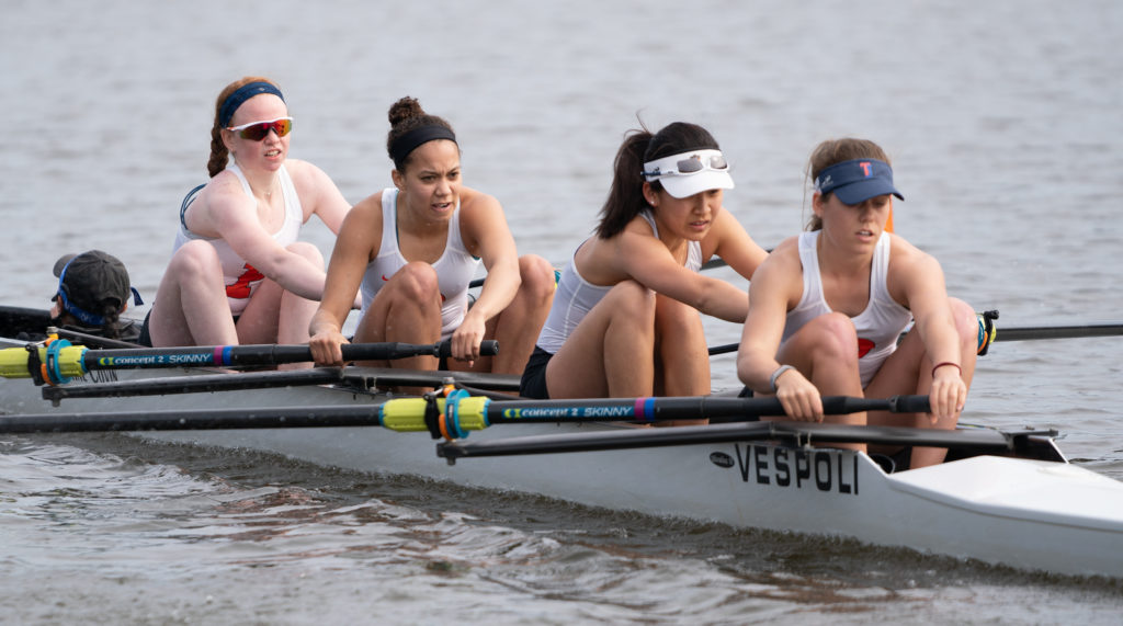 A group of people rowing a boat in the water