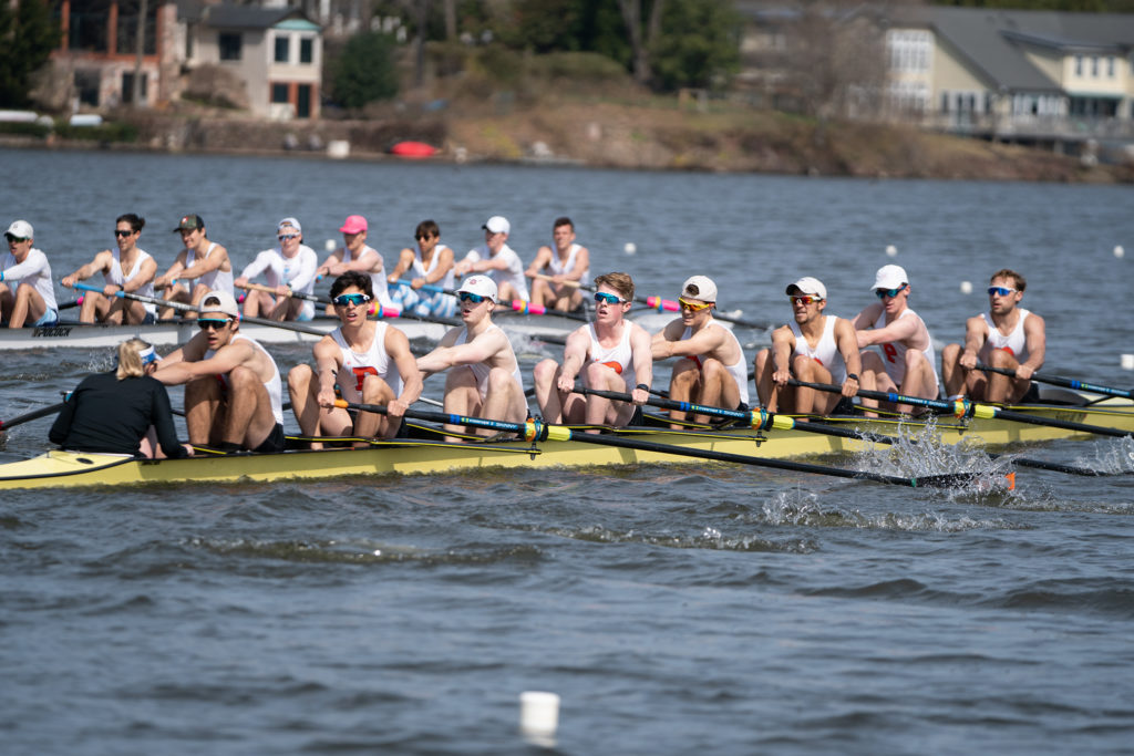 A group of people rowing a boat in the water