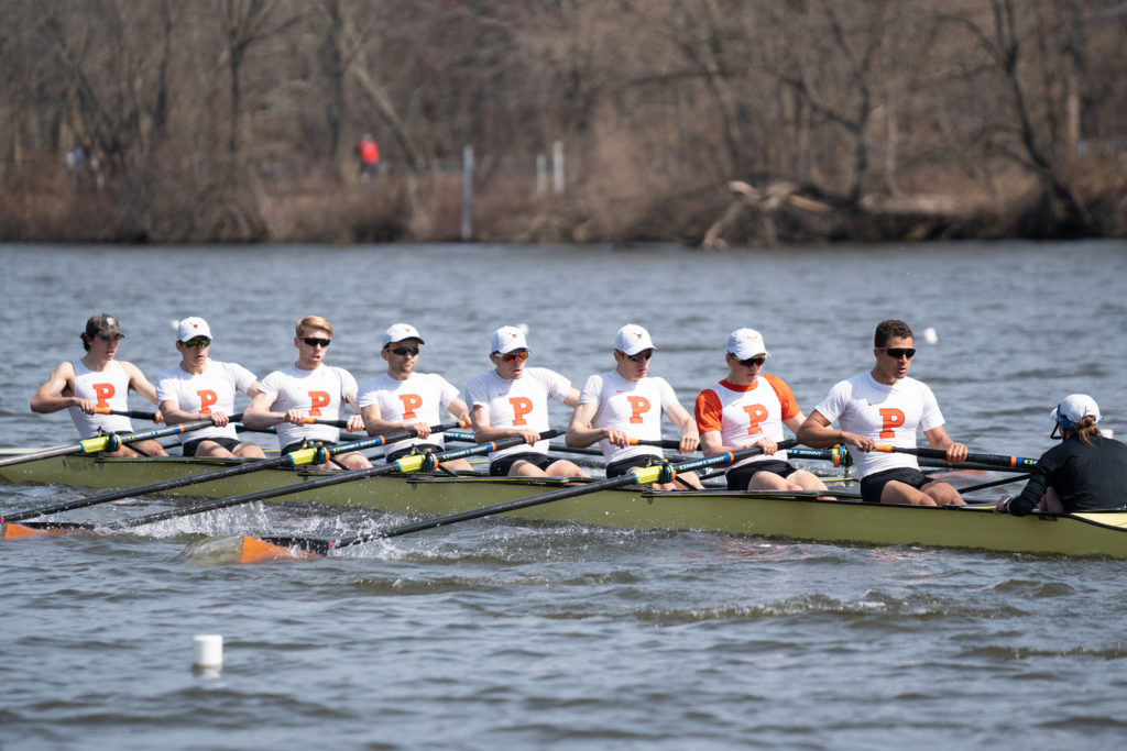 A group of people rowing a boat in the water