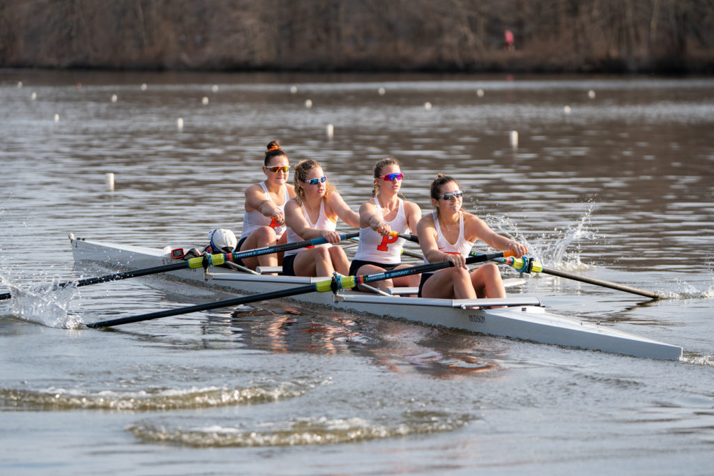 A group of people rowing a boat in the water