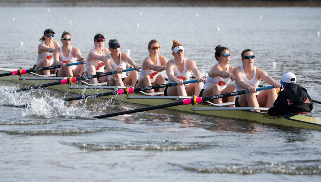 A group of people rowing a boat in the water