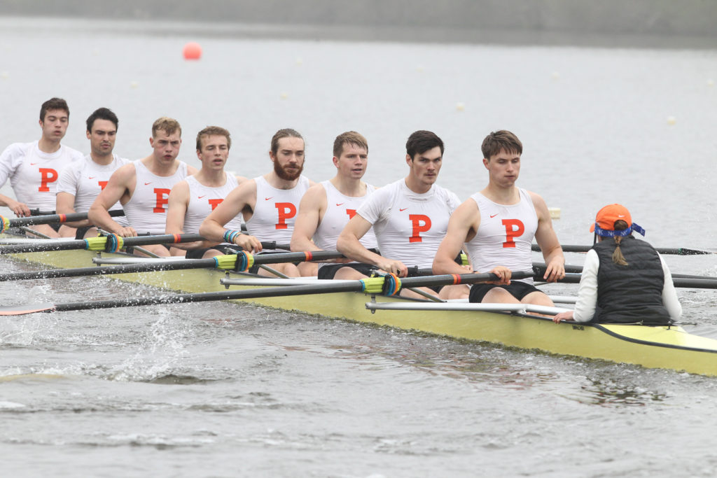 A group of people rowing a boat in the water