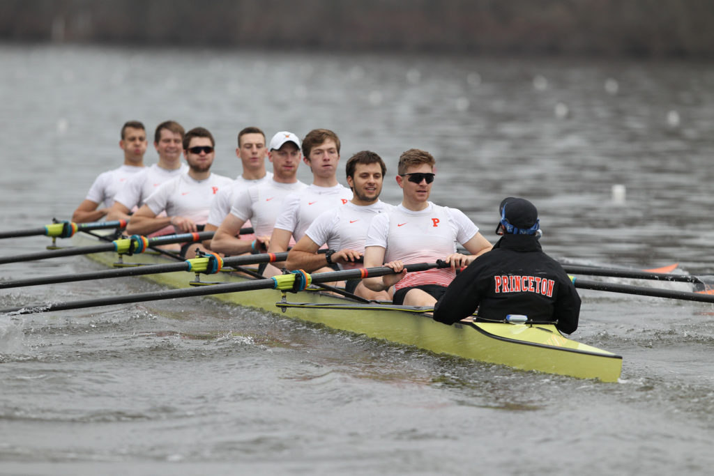 A group of people rowing a boat in the water