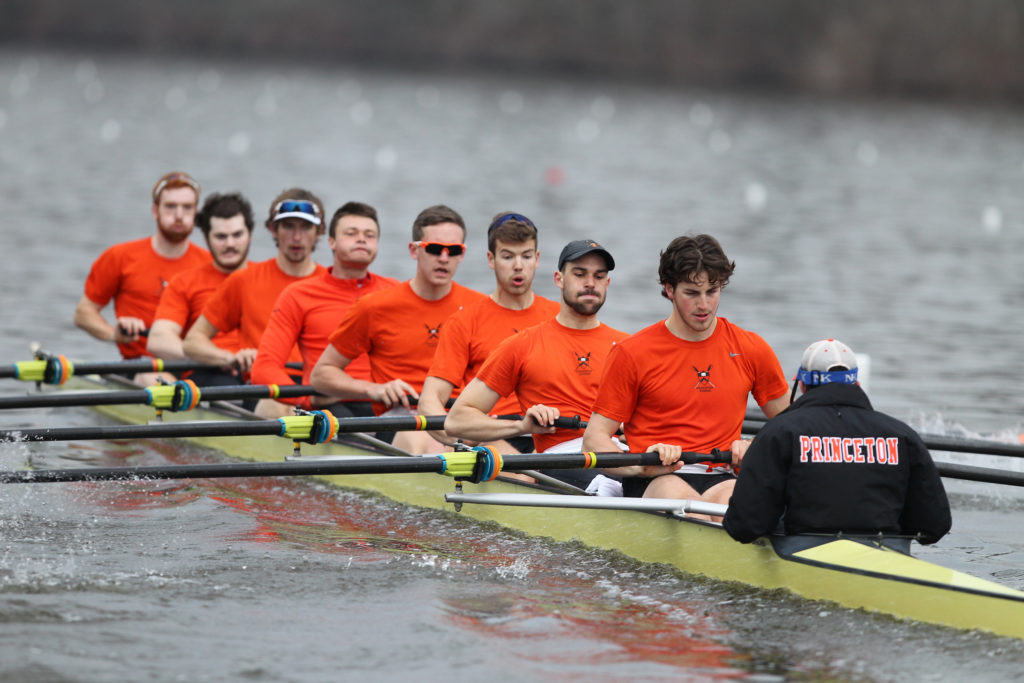 A group of people rowing a canoe