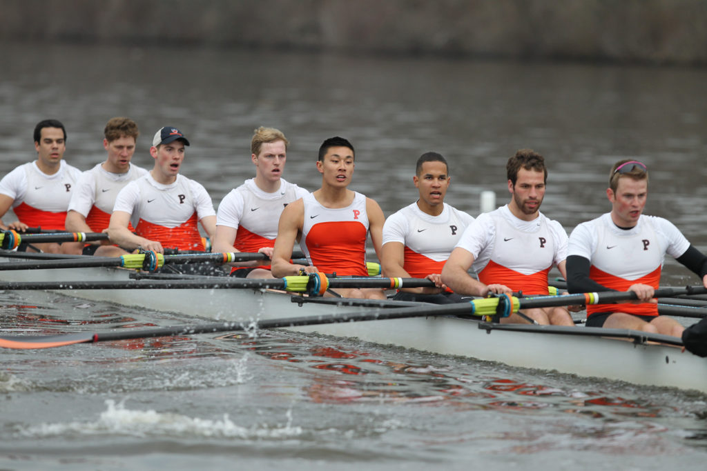 A group of people rowing a boat in the water