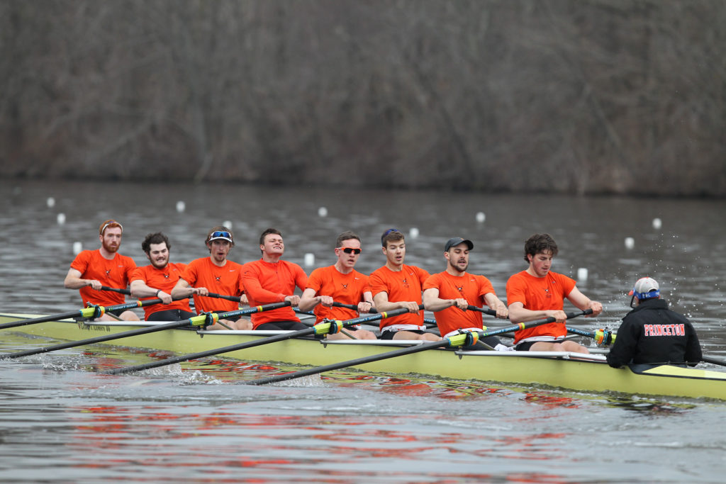 A group of people rowing a boat in the water