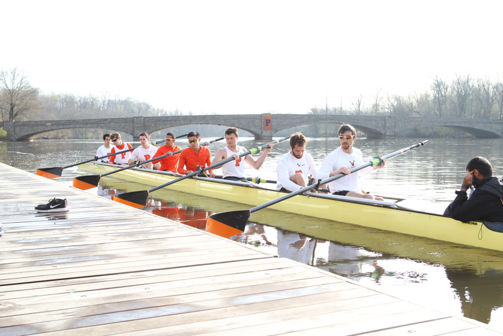 A group of people rowing a boat in the water