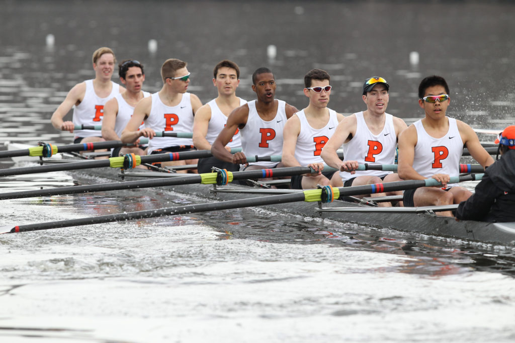 A group of people rowing a boat in the water