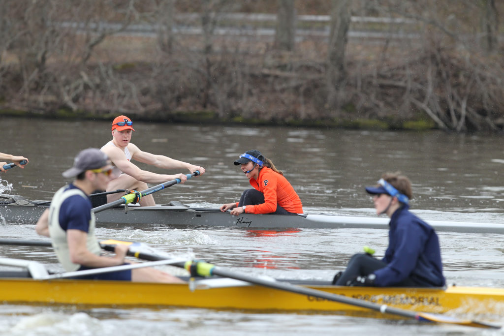 A group of people rowing a boat in the water