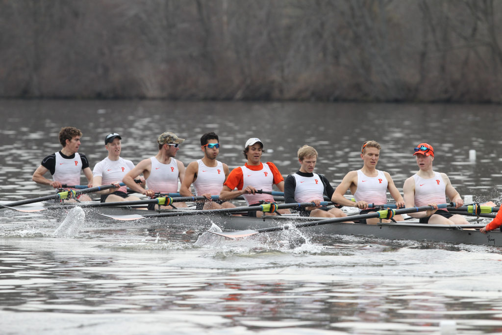 A group of people rowing a boat in the water