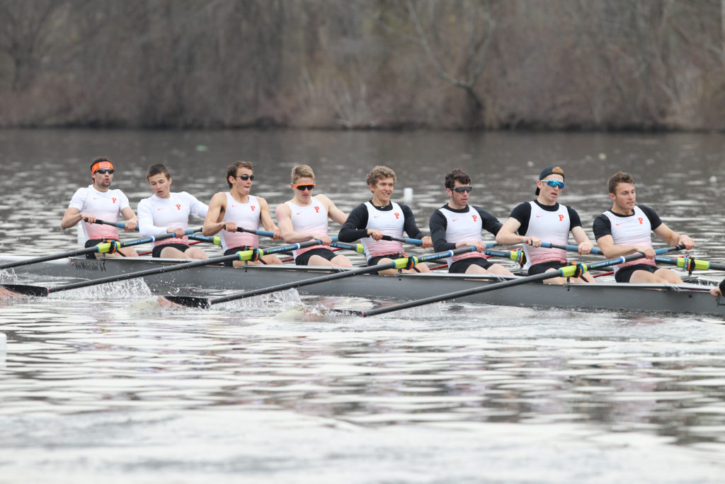 A group of people rowing a boat in the water