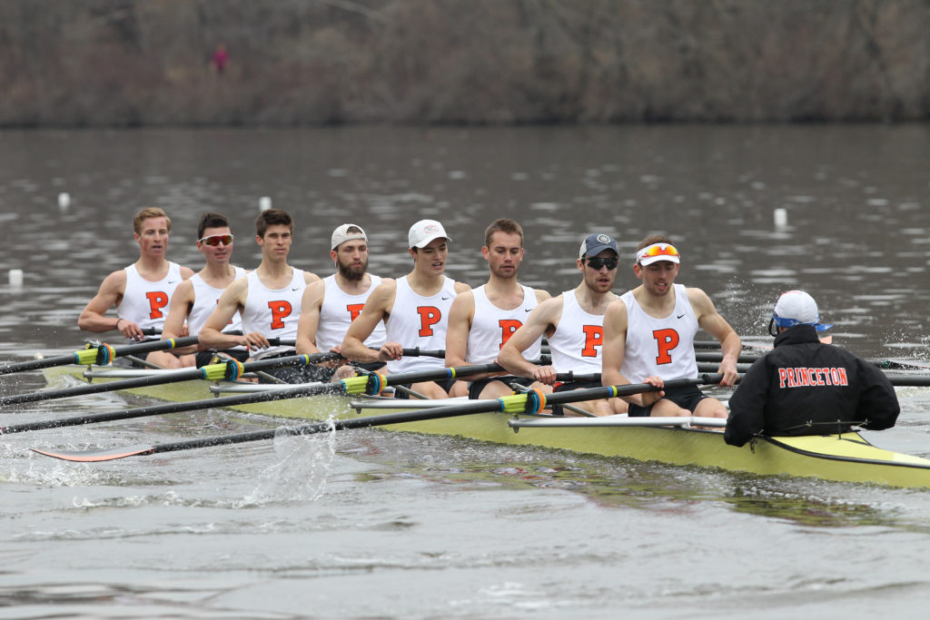 A group of people rowing a boat in the water