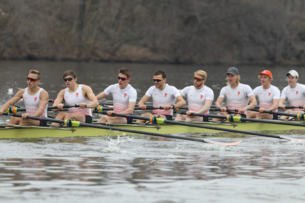 A group of people rowing a boat in the water