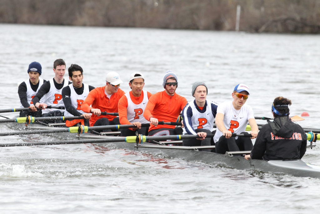 A group of people rowing a boat in the water