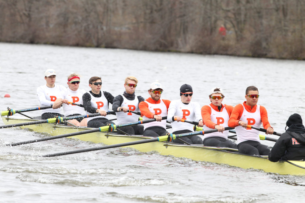 A group of people rowing a boat in the water