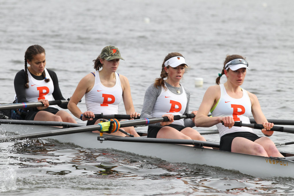 A group of people rowing a boat in the water