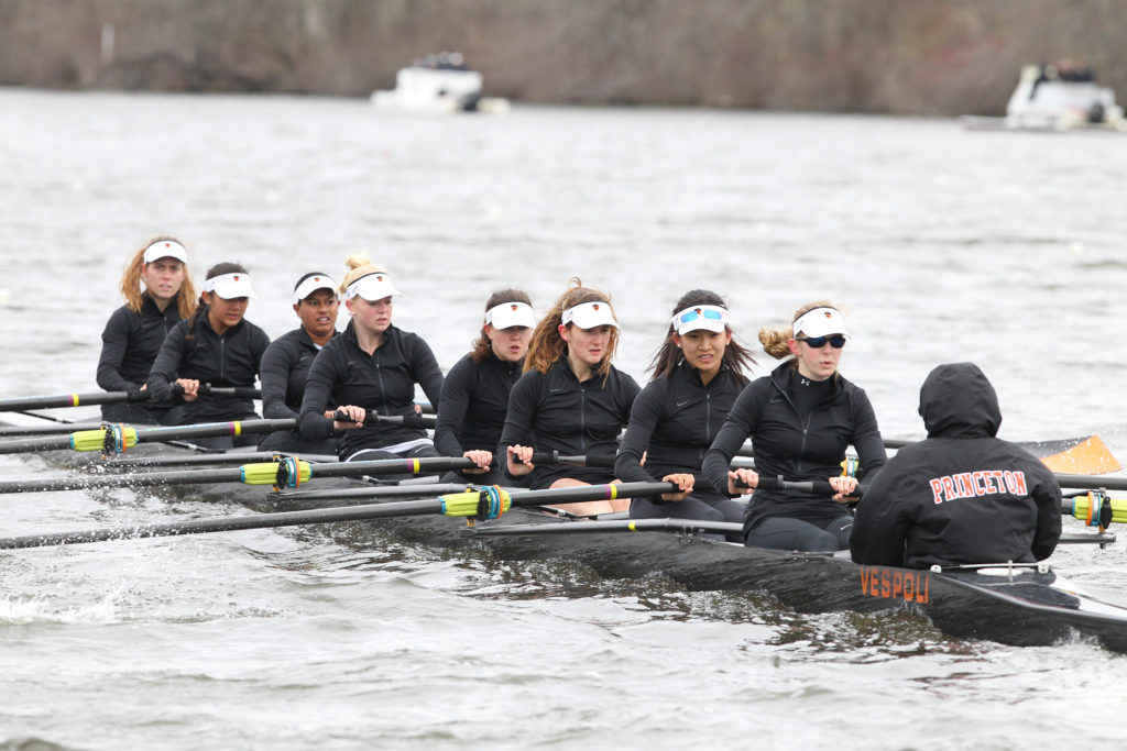 A group of people rowing a boat in the water