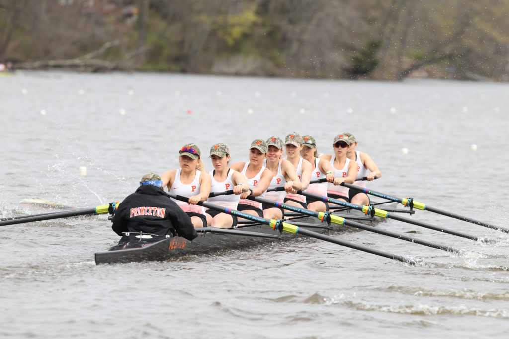 A group of people rowing a boat in the water