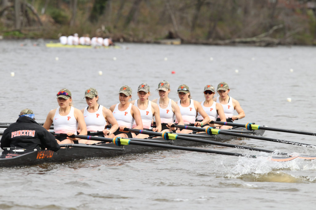 A group of people rowing a boat in the water