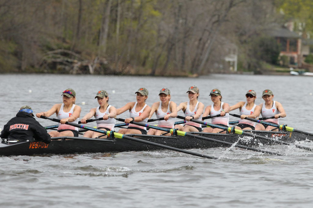 A group of people rowing a boat in the water