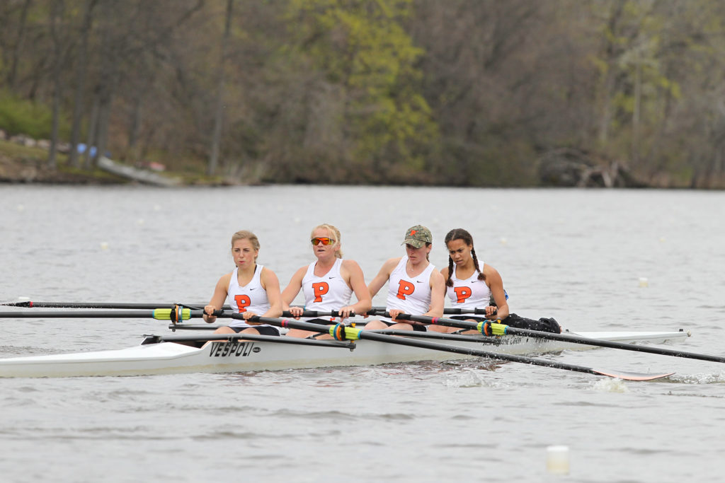 A group of people rowing a boat in the water