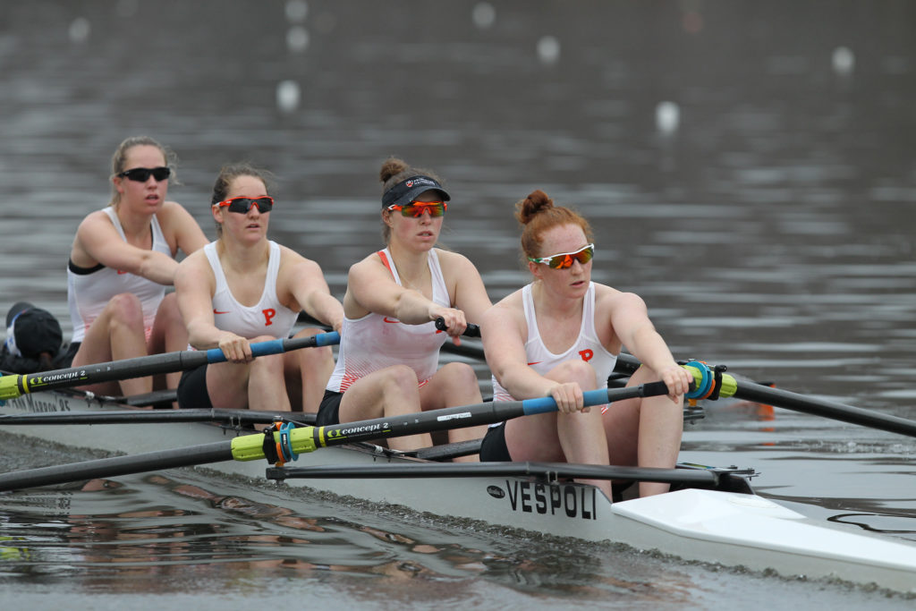 A group of people rowing a boat in the water