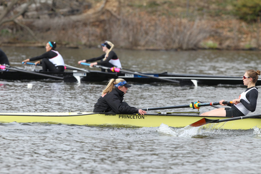 A group of people rowing a boat in the water