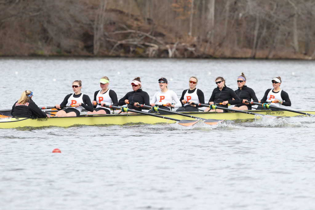 A group of people rowing a boat in the water