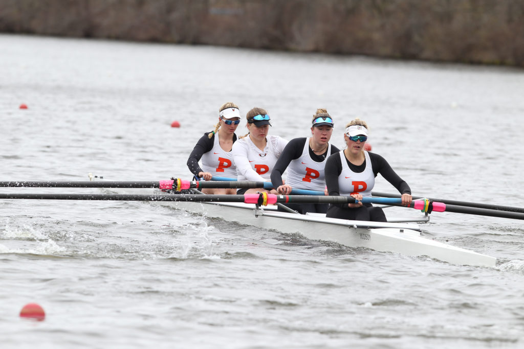 A group of people rowing a boat in the water